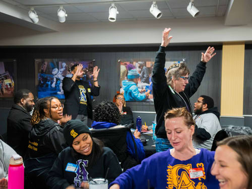 Educators in workshop reacting to a colleague in motion doing a walking activity 