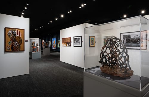 Gallery of artwork with lattice-like sculpture in foreground 
