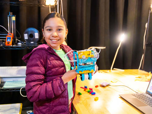Camper in Fab Lab shows off a creation