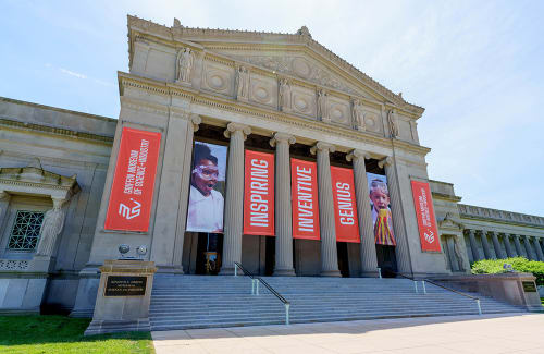 Facade of the Museum's North Portico with banners reading "Inspiring Inventive Genius"