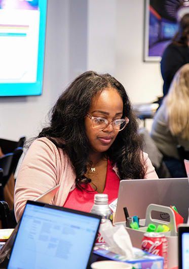 Educator working on a laptop during a workshop