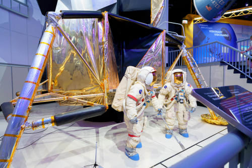 Lunar landing training module displayed with two spacesuited figures