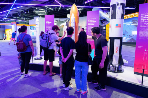 Group of guests looking at a rocket model display