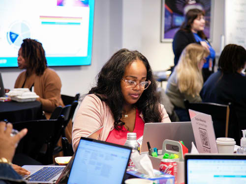 Educator working on a laptop during a workshop