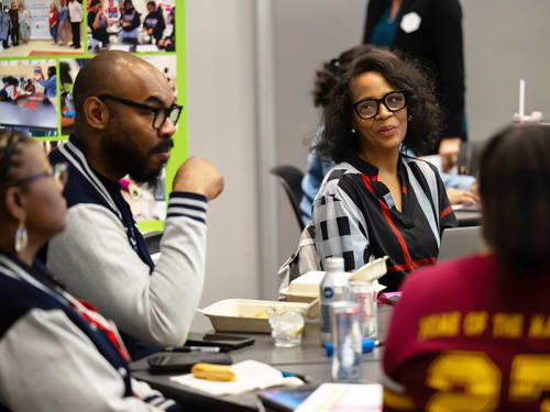 Educators seated around a conference table 